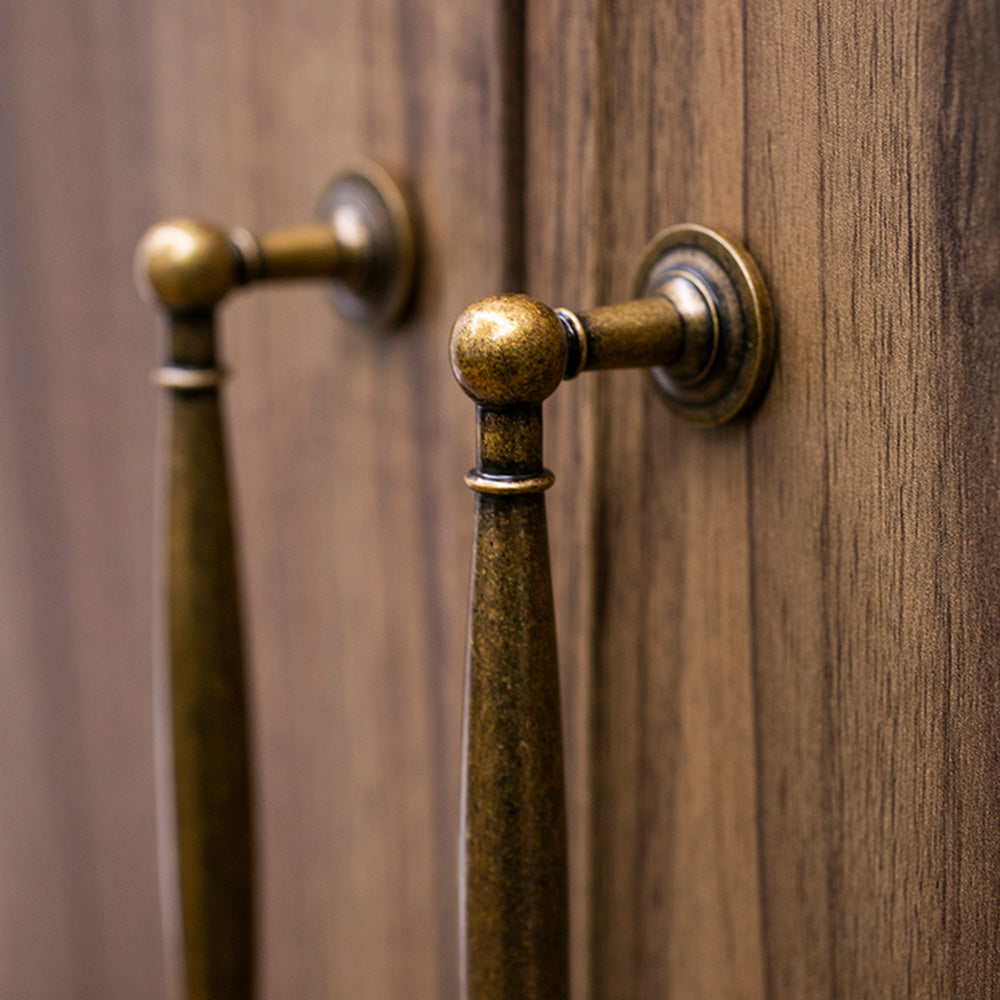 Brass round bar cabinet pull and round knob, pictured in one view in an installed cabinet close-up