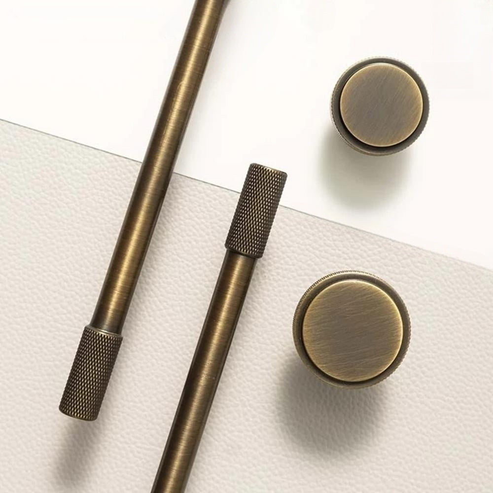 Bronze knurled T-bar cabinet pull and round knob, shown from one angle as a color and finish lineup