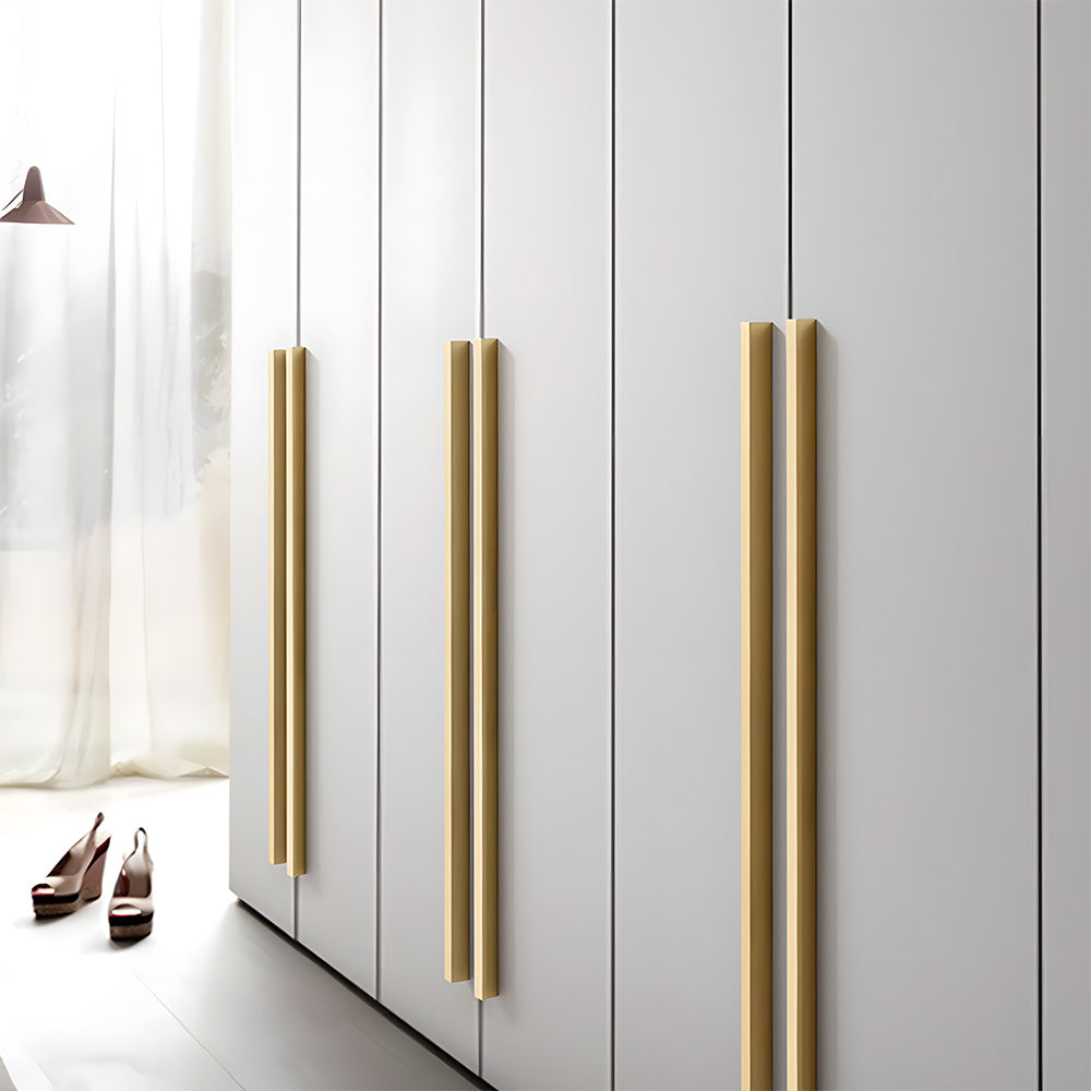 Gold brass L-profile cabinet pull, shown clearly mounted on a finished cabinet front
