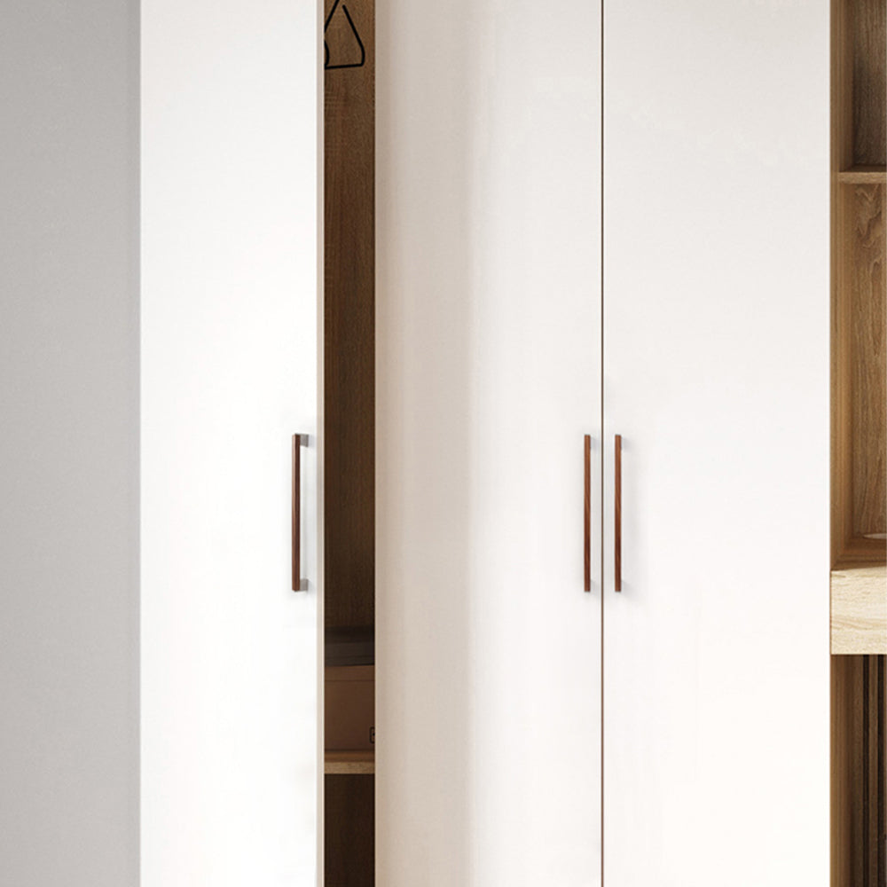 Black walnut wood T-bar cabinet pull with silver-toned ends, shown on tall wardrobe doors in a bedroom setting