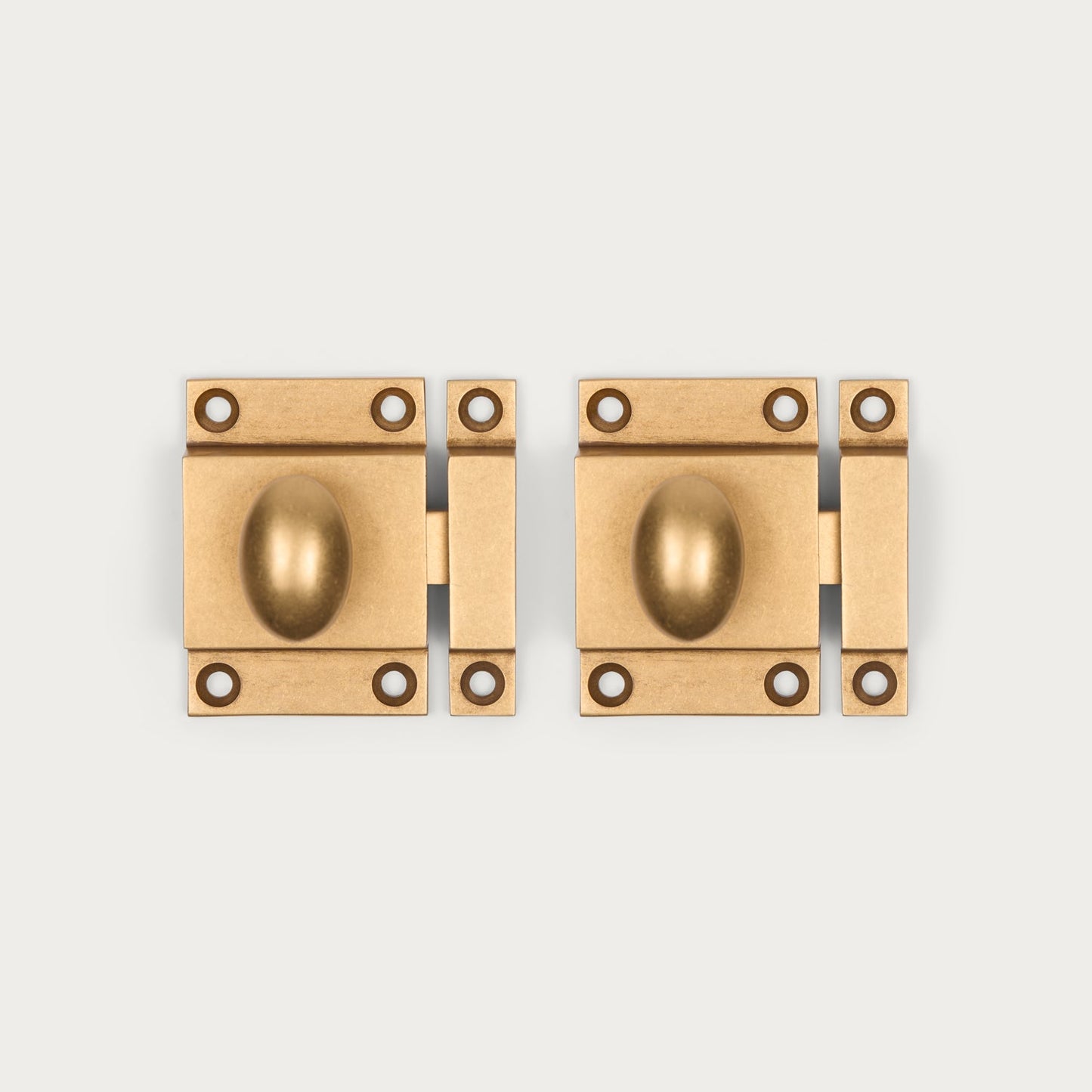 Two antique brass cabinet latches shown side-by-side on a light gray background.