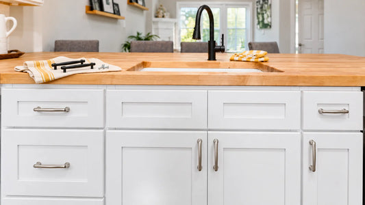 White kitchen island cabinets with silver cabinet pulls and knobs