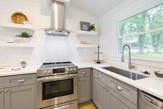 Brushed nickel cabinet pulls and knobs on gray kitchen cabinets
