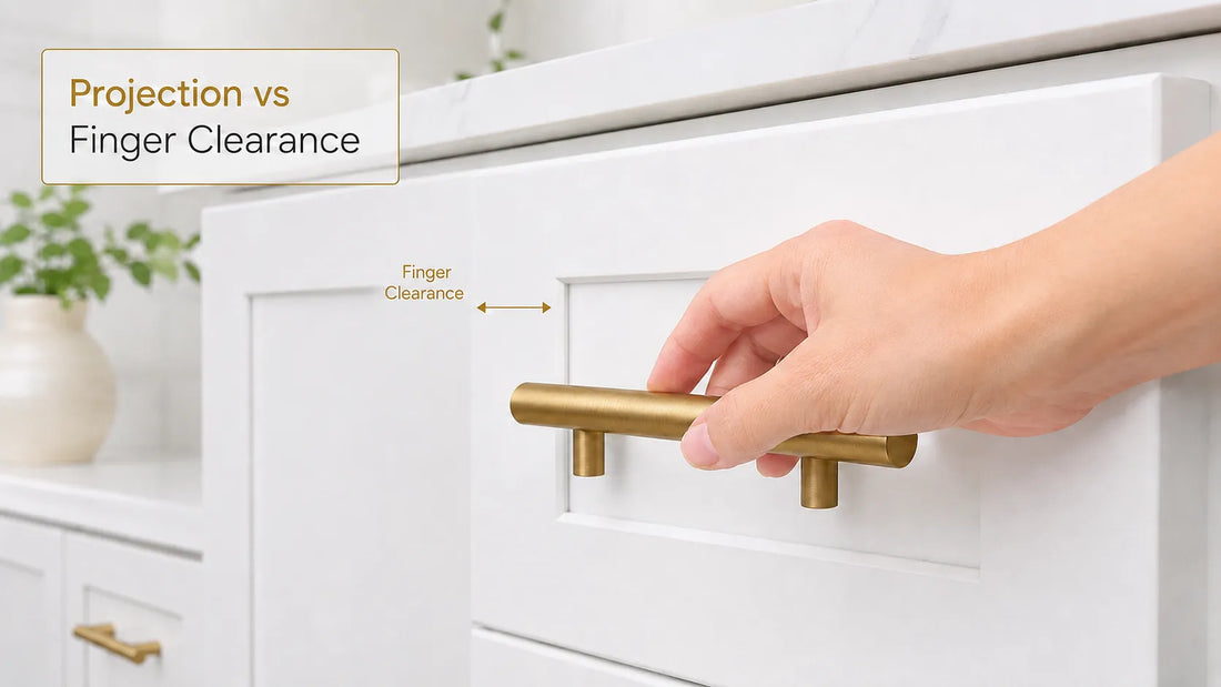 Hand testing finger clearance behind a brass cabinet pull on a white Shaker drawer