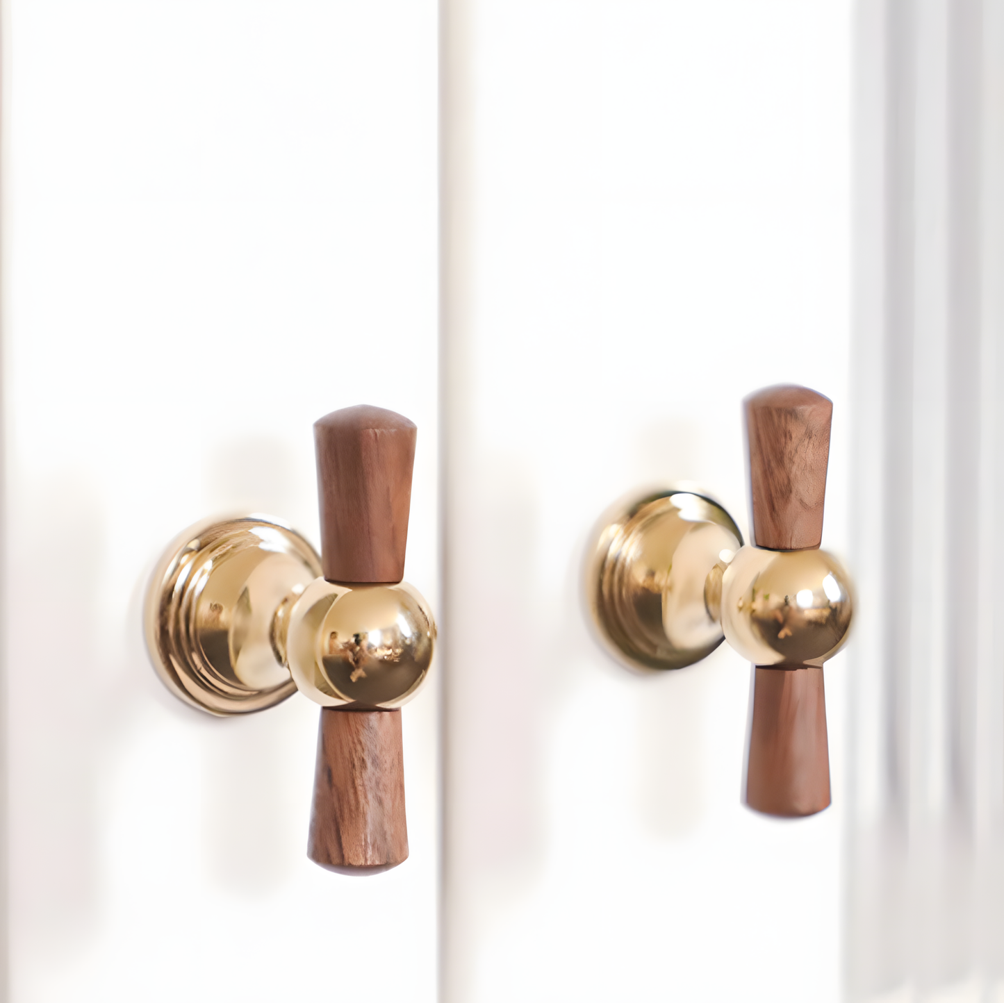 Wood T-bar cabinet pull with round metal pedestal mounts, presented for reference installed on cabinetry in context