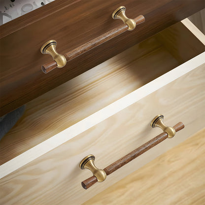 Wood T-bar cabinet pull with round metal pedestal mounts, displayed from the side installed on cabinetry in context