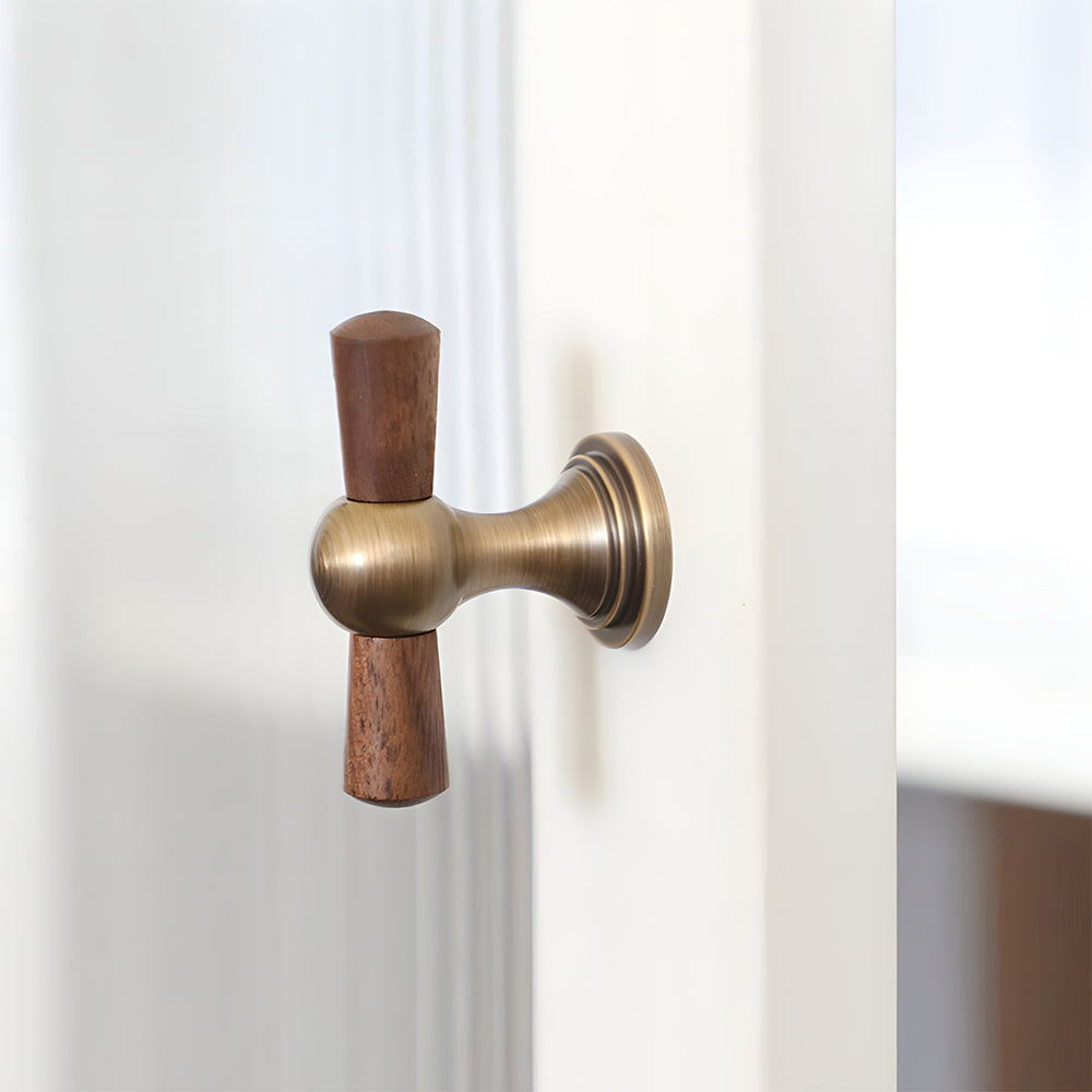 Wood T-bar cabinet pull with round metal pedestal mounts, shown clearly mounted on a finished cabinet front