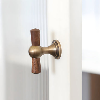 Wood T-bar cabinet pull with round metal pedestal mounts, shown clearly mounted on a finished cabinet front
