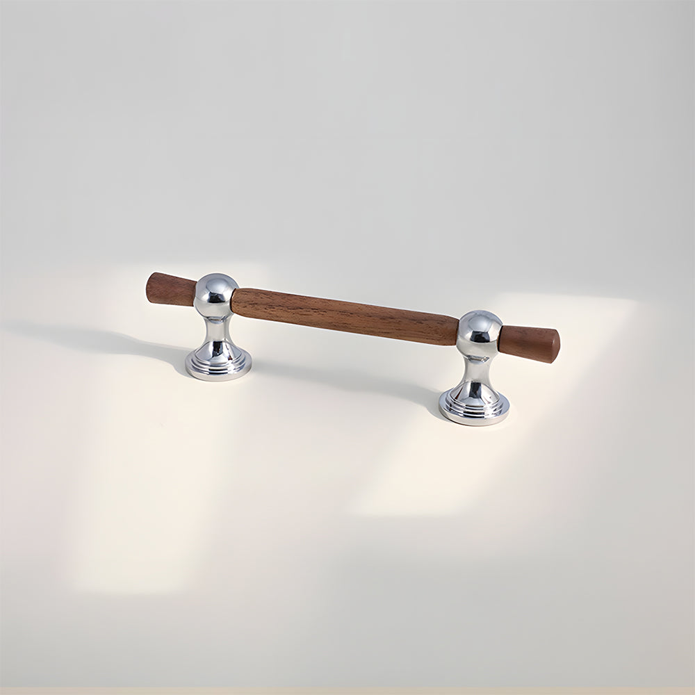 Wood T-bar cabinet pull with round metal pedestal mounts, shown at close range on a clean neutral background