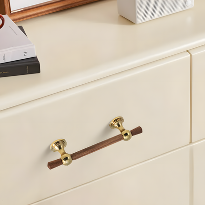 Wood T-bar cabinet pull with round metal pedestal mounts, shown in a focused view mounted on a finished cabinet front