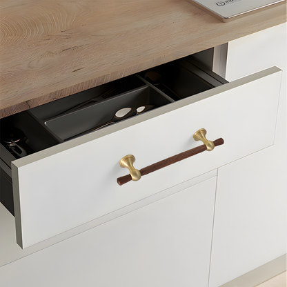 Wood T-bar cabinet pull with round metal pedestal mounts, shown from one angle installed on cabinetry in context