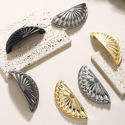 Shell-shaped cabinet cup pull, shown clearly as a color and finish lineup with key hardware details visible