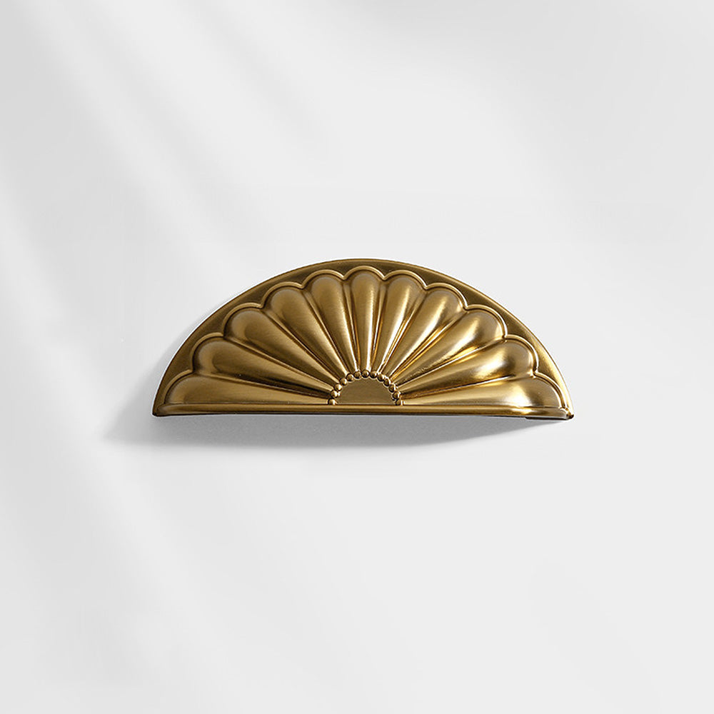 Shell-shaped cabinet cup pull, shown from one angle on a clean neutral background