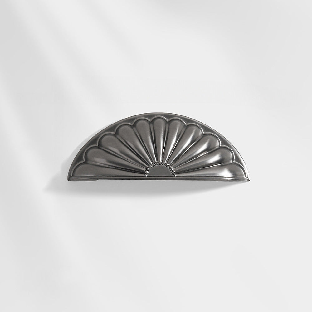 Shell-shaped cabinet cup pull, displayed from the side on a clean neutral background