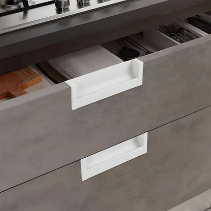 White recessed aluminum finger edge pull, pictured in one view installed on cabinetry in context