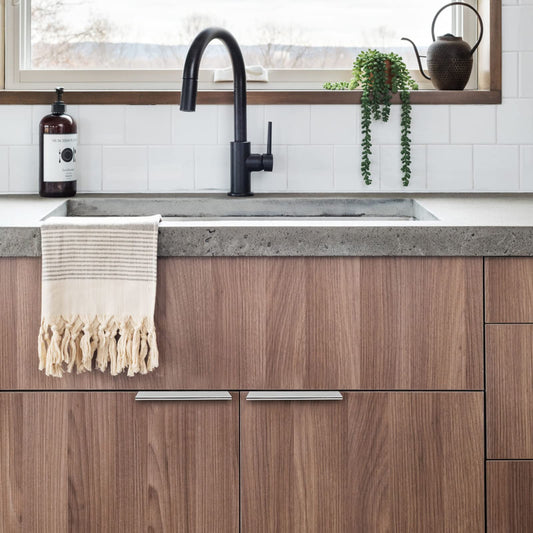 Silver square aluminum cabinet edge pull, shown in a focused view installed on cabinetry in context