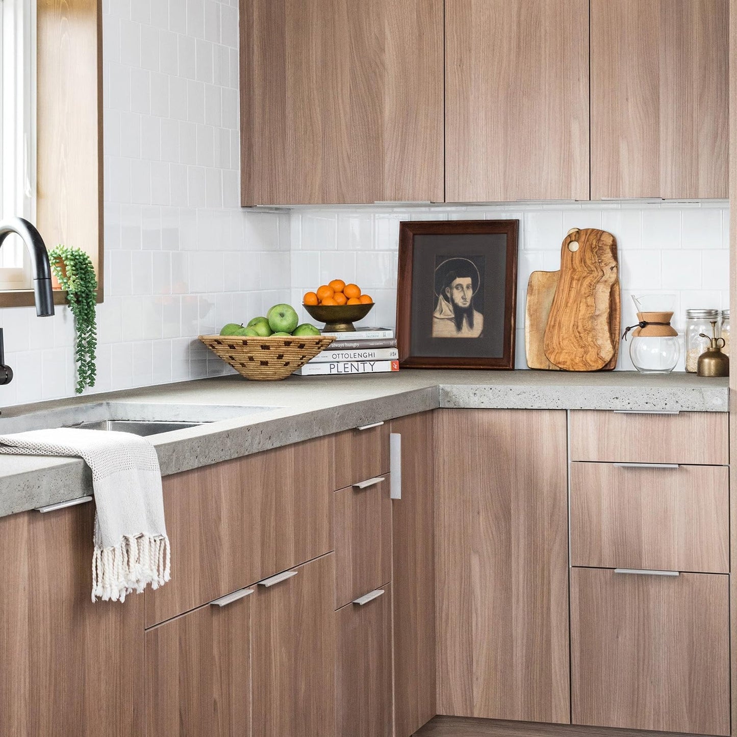 Square aluminum cabinet edge pull, presented in another view installed on cabinetry in context