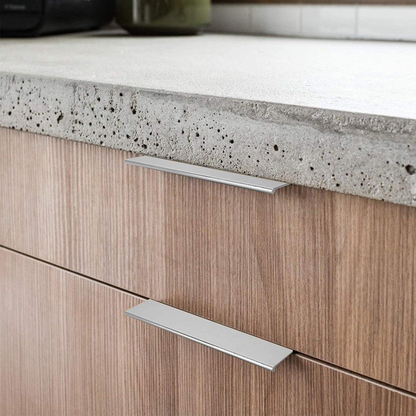 Silver square aluminum cabinet edge pull, presented for reference in an installed cabinet close-up