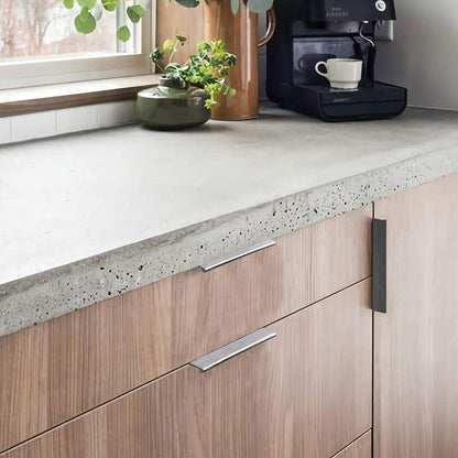 Square aluminum cabinet edge pull, shown clearly mounted on a finished cabinet front