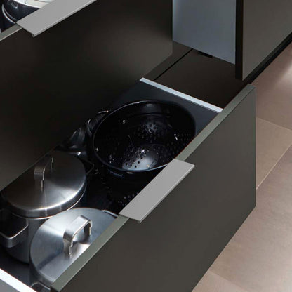 Silver square aluminum cabinet edge pull, displayed from the side mounted on a finished cabinet front