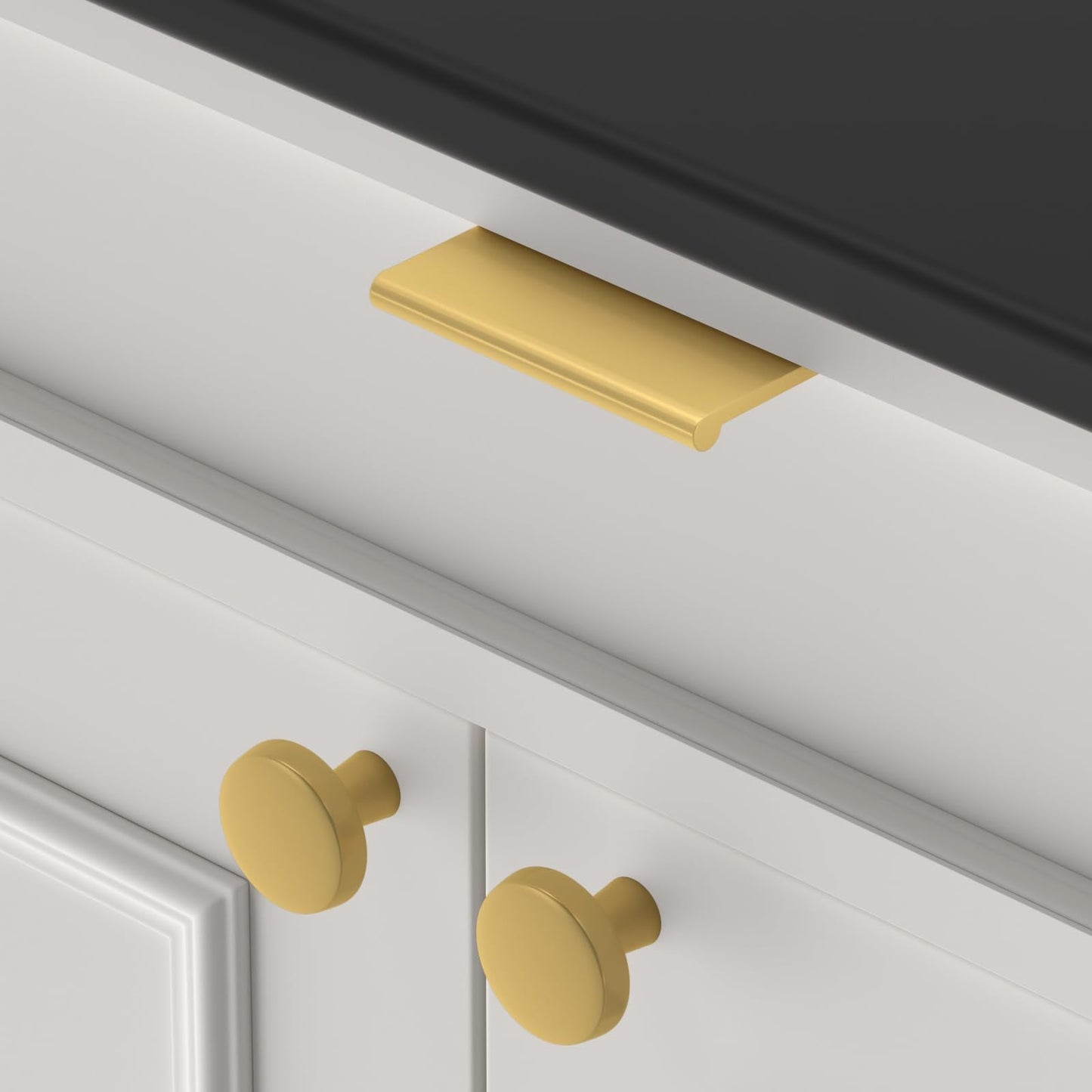 Brushed brass square aluminum cabinet edge pull, shown in a focused view in an installed cabinet close-up