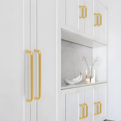 Gold rounded aluminum cabinet pull, presented for reference installed on cabinetry in context