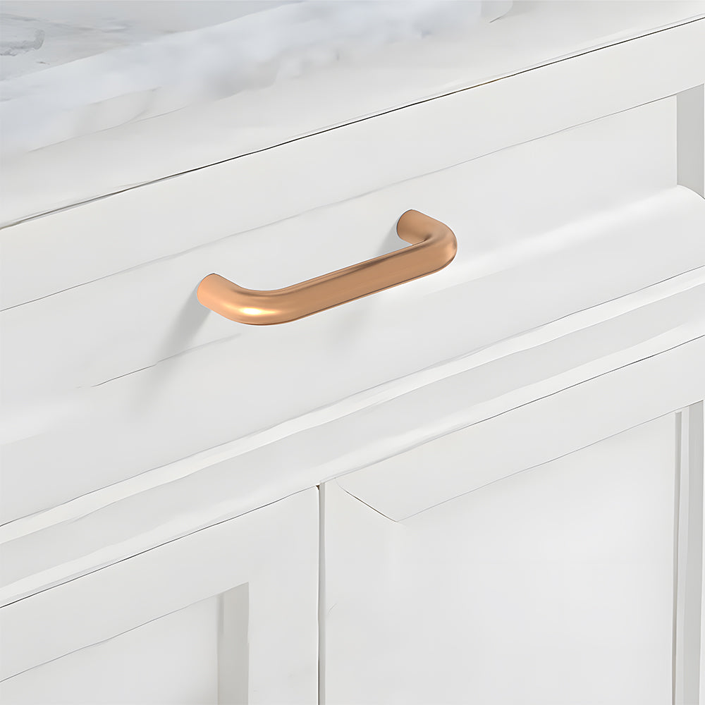 Champagne bronze rounded aluminum cabinet pull, presented in another view mounted on a finished cabinet front