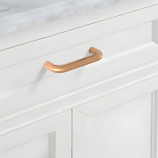 Champagne bronze rounded aluminum cabinet pull, presented in another view mounted on a finished cabinet front