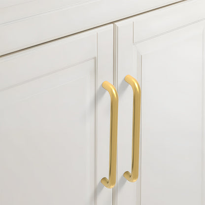 Gold rounded aluminum cabinet pull, shown from one angle installed on cabinetry in context