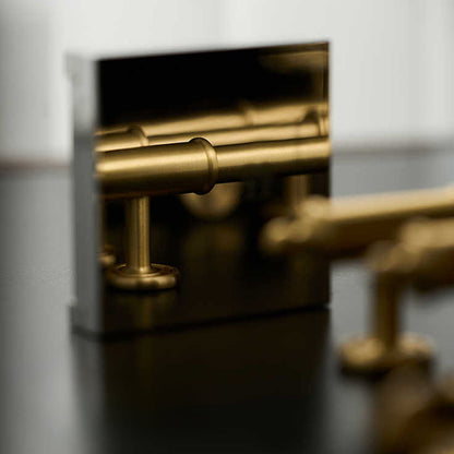 Antique brass round bar cabinet pull with matching T-knob, shown clearly with its construction and finish visible