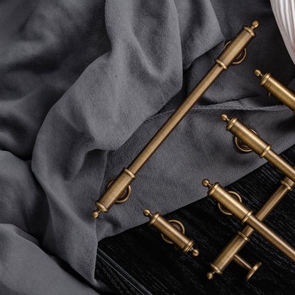 Antique brass round bar cabinet pull with matching T-knob, presented in another view as a color and finish lineup