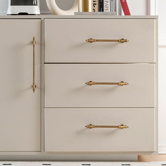 Antique brass round bar cabinet pull with matching T-knob, presented for reference installed on cabinetry in context