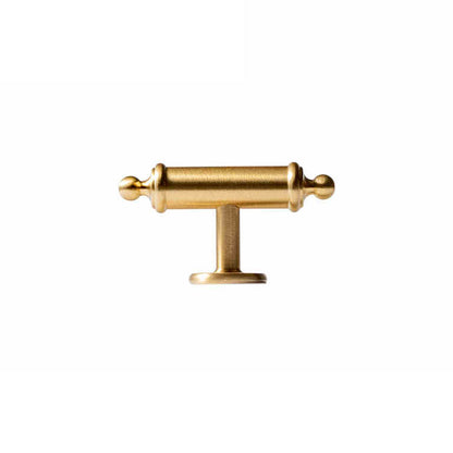 Antique brass round bar cabinet pull with matching T-knob, shown in a focused view on a clean neutral background