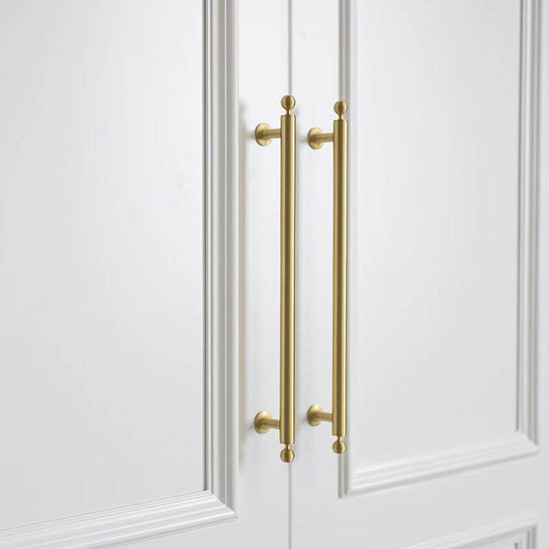 Antique bronze cabinet pull with matching ribbed knob, presented for reference in an installed cabinet close-up