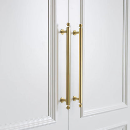 Antique bronze cabinet pull with matching ribbed knob, presented for reference in an installed cabinet close-up