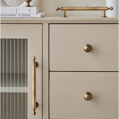 Antique bronze cabinet pull with matching ribbed knob, shown clearly installed on cabinetry in context