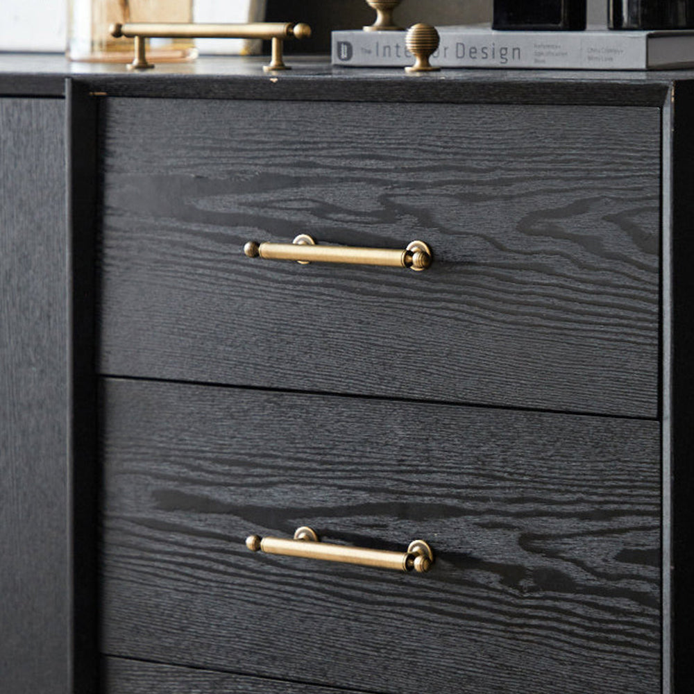 Antique bronze cabinet pull with matching ribbed knob, shown at close range installed on cabinetry in context
