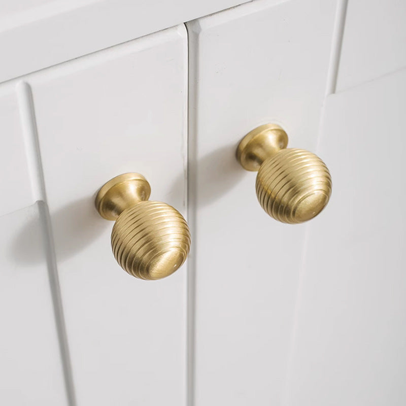 Antique bronze cabinet pull with matching ribbed knob, shown clearly with the finish and grip area visible