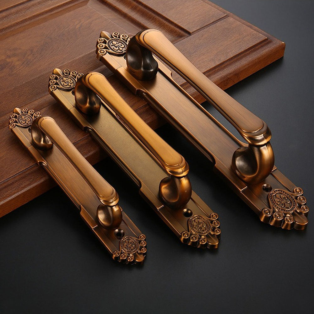 Antique bronze cabinet pull with decorative floral backplate, shown clearly as a color and finish lineup