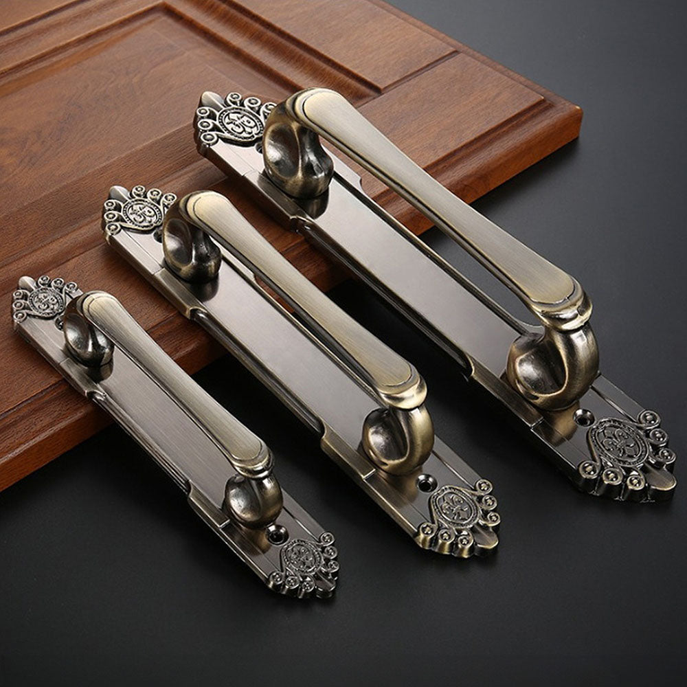 Antique bronze cabinet pull with decorative floral backplate, pictured in one view as a color and finish lineup