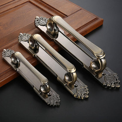 Antique bronze cabinet pull with decorative floral backplate, pictured in one view as a color and finish lineup