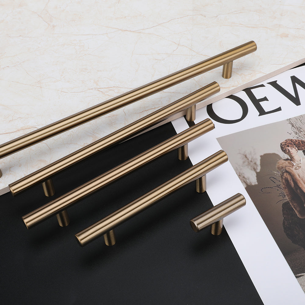 Round T-bar antique bronze cabinet pull, shown from one angle with related hardware in one display