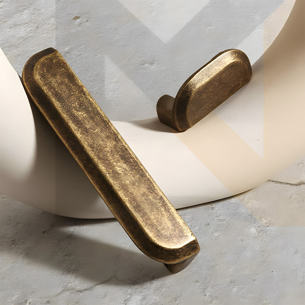 Antique bronze recessed cabinet pull, shown clearly with related hardware in one display