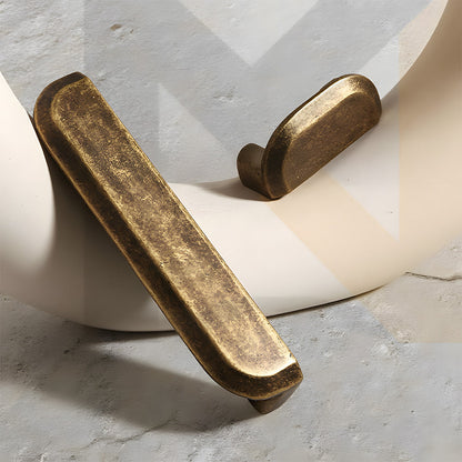 Antique bronze recessed cabinet pull, shown clearly with related hardware in one display