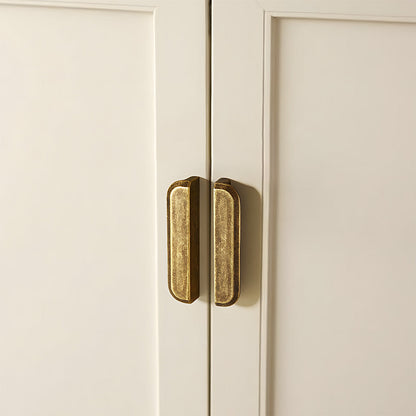 Antique bronze recessed cabinet pull, shown from one angle in an installed cabinet close-up
