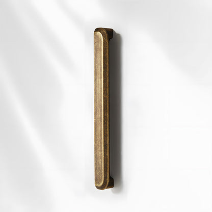 Antique bronze recessed cabinet pull, shown from one angle on a clean neutral background