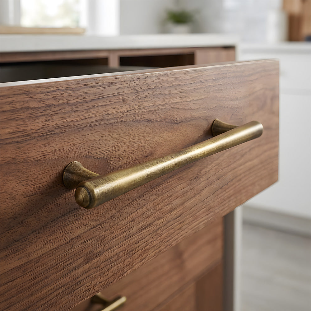 Antique bronze round bar cabinet pull, pictured in one view in an installed cabinet close-up