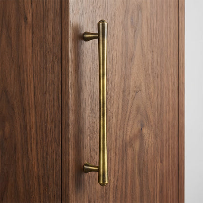 Antique bronze round bar cabinet pull, shown at close range in an installed cabinet close-up