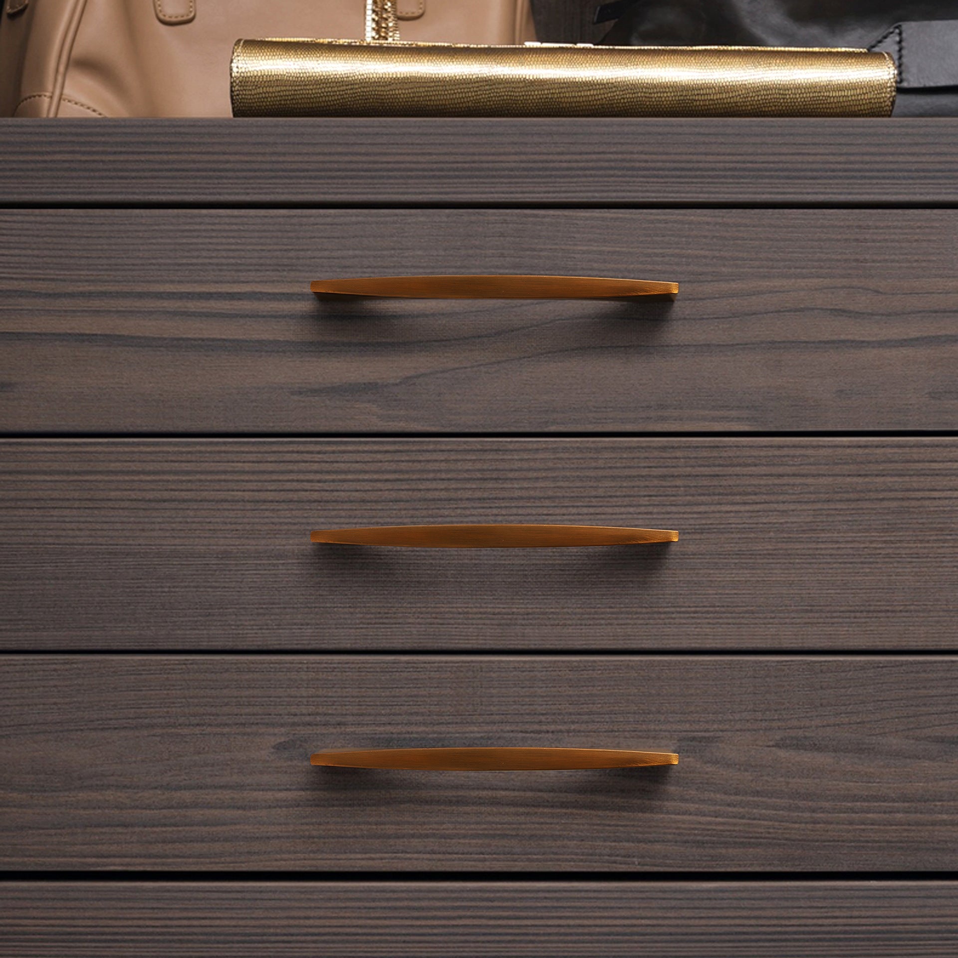 Arched aluminum cabinet pull, shown at close range installed on cabinetry in context