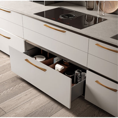 Arched aluminum cabinet pull, shown in a focused view installed on cabinetry in context